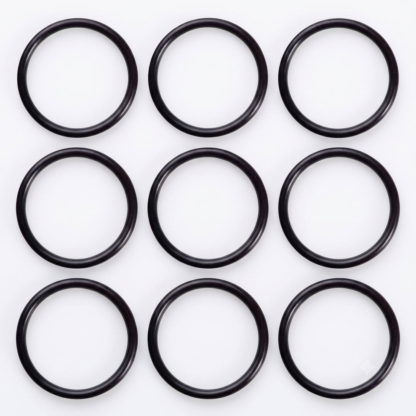 A neat 3 x 3 grid arrangement of nine black rubber Hansgrohe 98066000 replacement O-ring seals, showcasing the spare plug washers for Flexaplus and Exafill bath wastes on a bright white background.