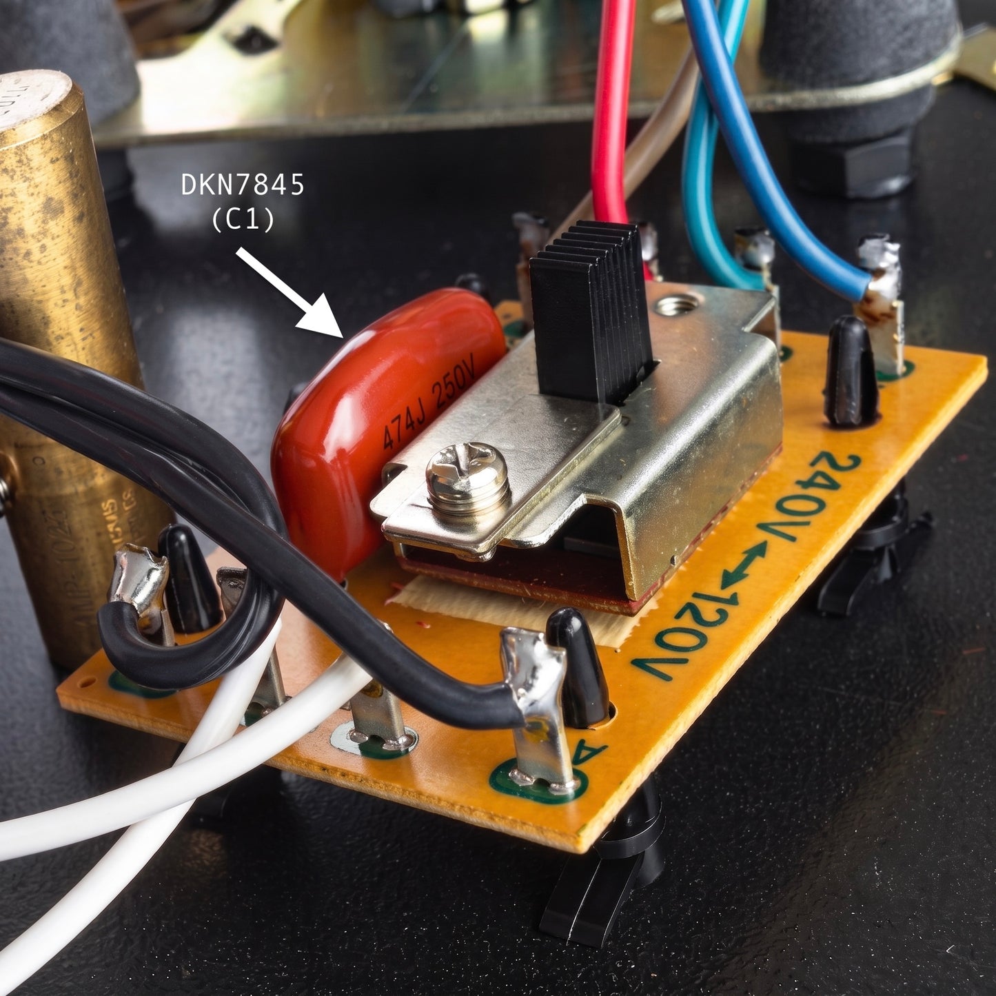 Close-up of a Pioneer PL-12D / PL-12E turntable motor repair PCB featuring a replacement 0.047uF (47nF) C1 capacitor marked 474J 250V, situated next to a 240V to 120V voltage selector switch with white, black, red, and blue wiring.