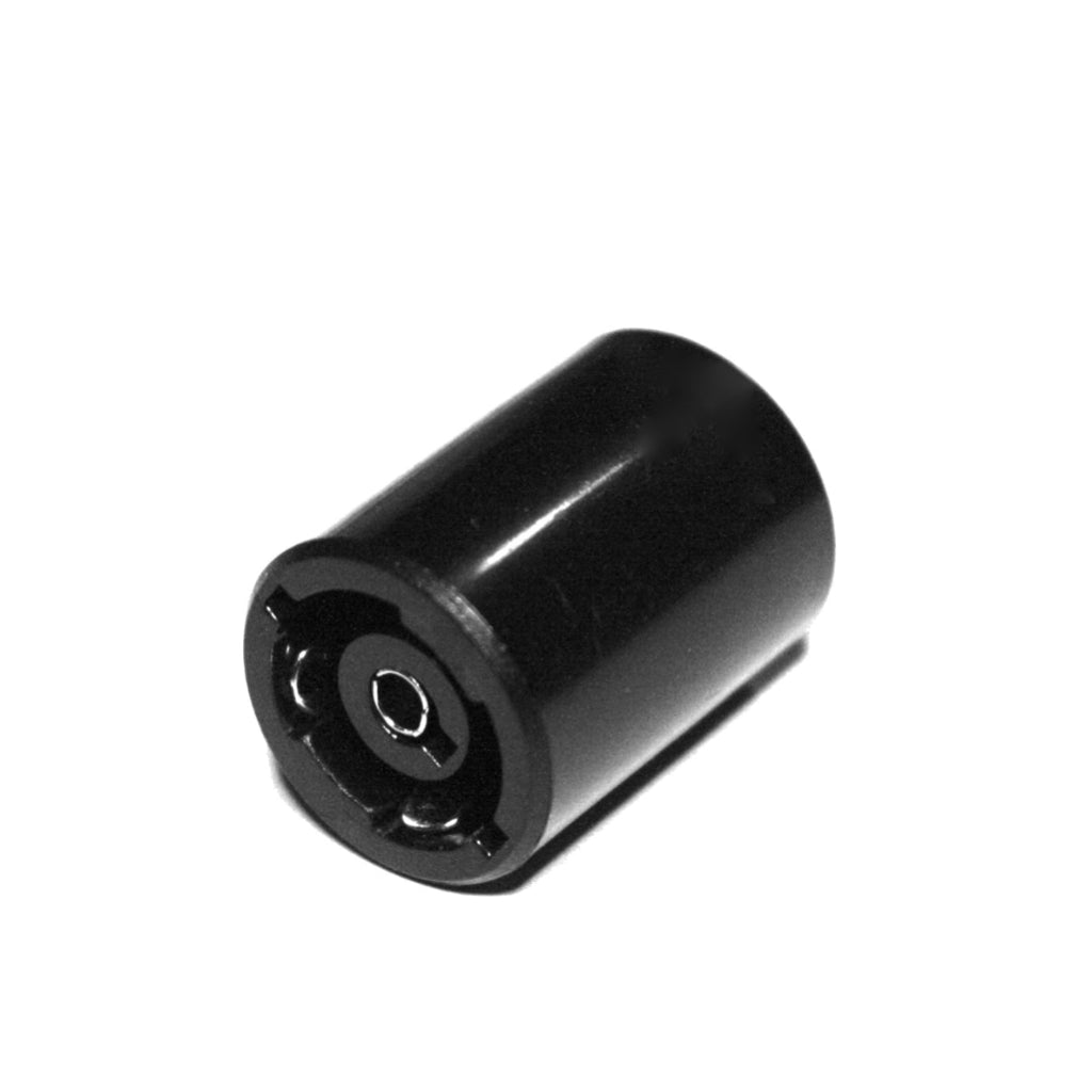 Black cylindrical object with a central hole on a white background