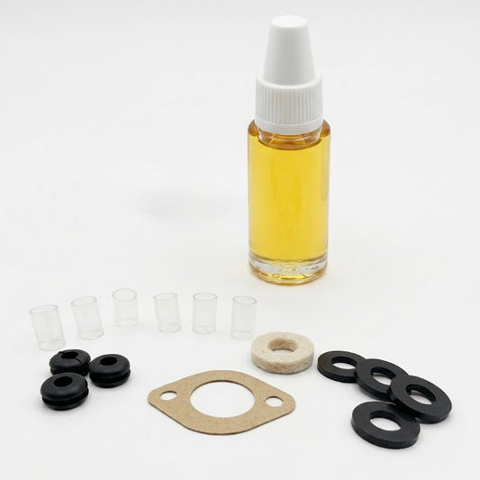 Bottle of yellow liquid with white cap, gaskets, and seals on a white background