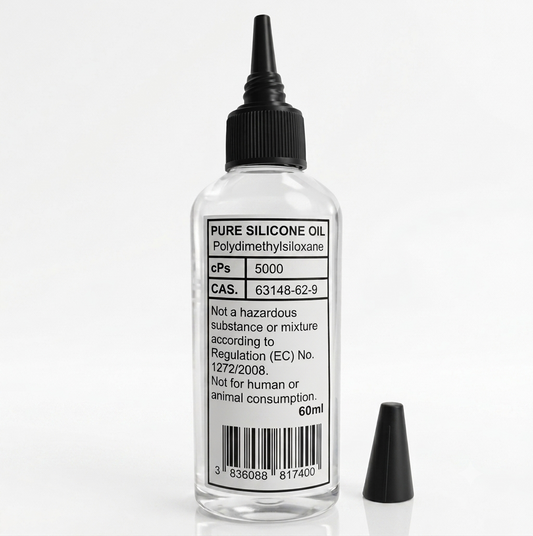 A clear plastic bottle containing clear silicone oil, with a black conical-tip applicator cap. The white label is printed with black text: “PURE SILICONE OIL”, “Polydimethylsiloxane”, “cPs 5000”, “CAS. 63148-62-9”, and the volume “60ml”. A smaller, separate black cap is positioned next to the bottl