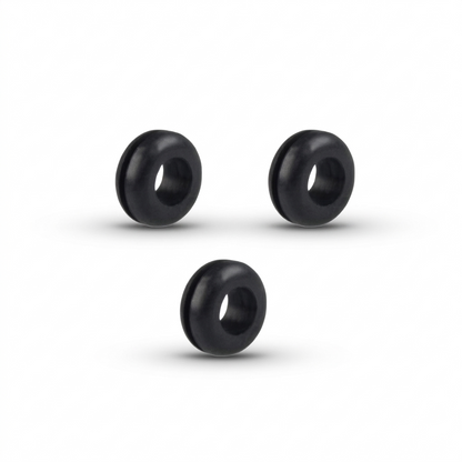 A studio shot of three identical black rubber isolation grommets, arranged in a triangle formation against a plain white background. The grommets are thick, doughnut-shaped rings with a deep groove running around their outer edge. Soft shadows are cast directly beneath each piece, highlighting their cylindrical depth and smooth, matte texture.