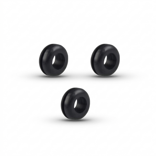 A studio shot of three identical black rubber isolation grommets, arranged in a triangle formation against a plain white background. The grommets are thick, doughnut-shaped rings with a deep groove running around their outer edge. Soft shadows are cast directly beneath each piece, highlighting their cylindrical depth and smooth, matte texture.