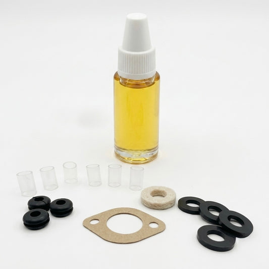 An assortment of Garrard maintenance components from a turntable service kit, arranged on a seamless white background.I