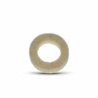 A close-up studio shot of a circular felt washer, viewed from directly above against a plain white background. The washer is thick and ring-shaped, with a fuzzy, textured surface in an off-white or cream colour. A soft, dark shadow is cast beneath it, giving the object a sense of depth.