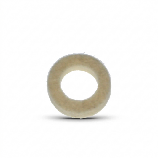 A close-up studio shot of a circular felt washer, viewed from directly above against a plain white background. The washer is thick and ring-shaped, with a fuzzy, textured surface in an off-white or cream colour. A soft, dark shadow is cast beneath it, giving the object a sense of depth.