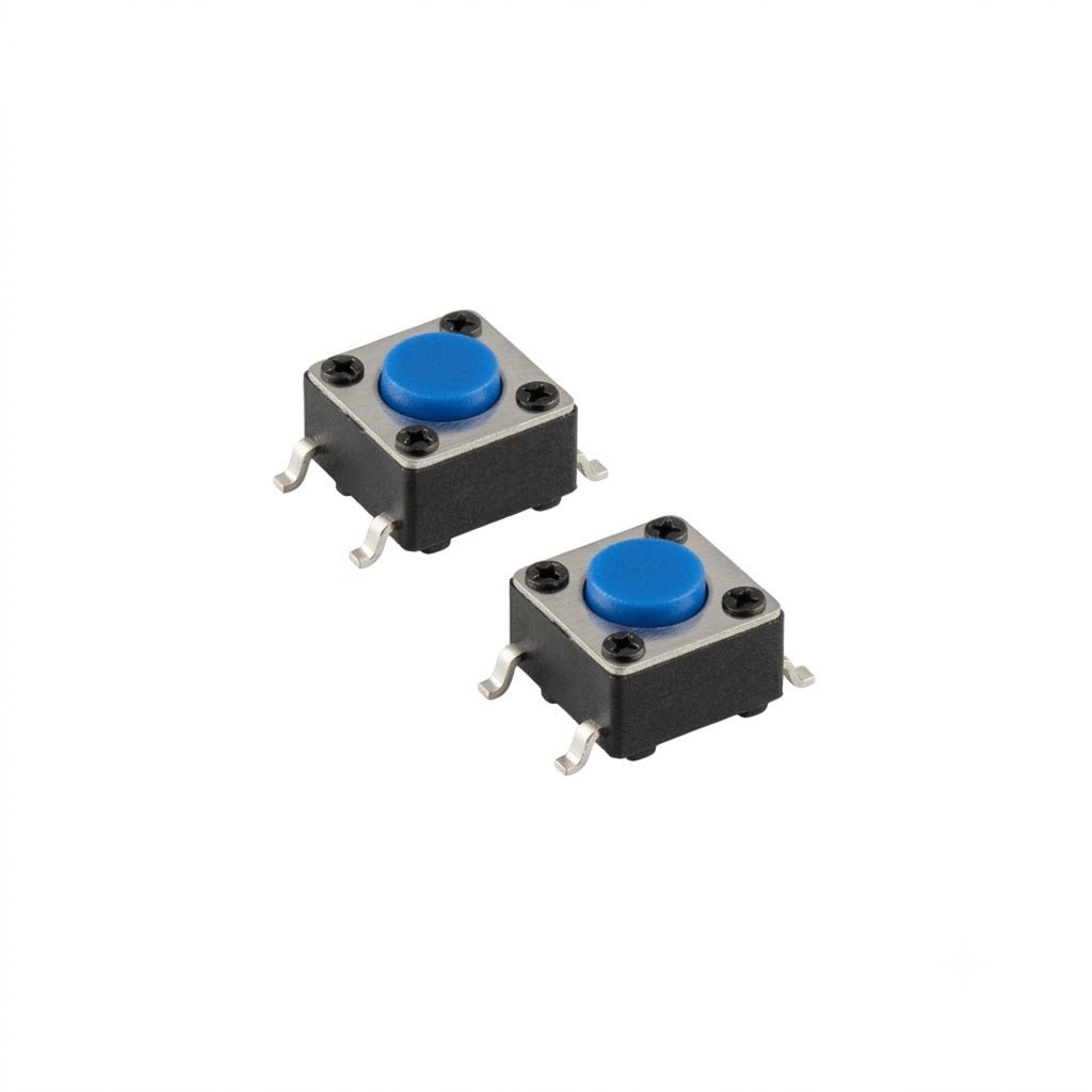 An isolated studio shot of a two-pack of upgraded power switches for a Gtech handheld vacuum, arranged diagonally against a seamless white background. Each component is a small, square tactile micro-switch featuring a black plastic housing body, a metallic silver top plate secured by four tiny rivets, and a vibrant blue circular push-button in the center. Four gull-wing shaped metallic solder leads extend from the sides for surface-mount installation.