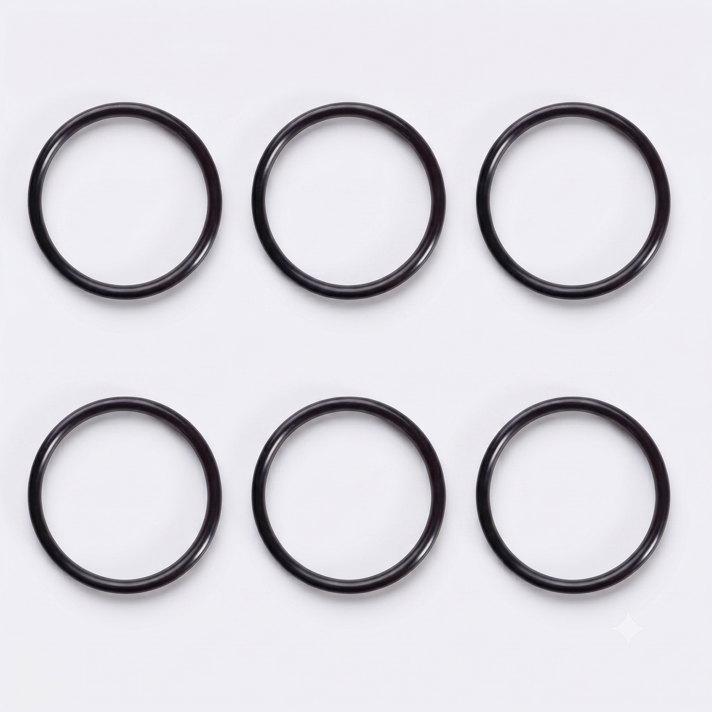 op-down view of six black rubber O-ring seals arranged neatly in a two-by-three grid against a clean, light grey background.