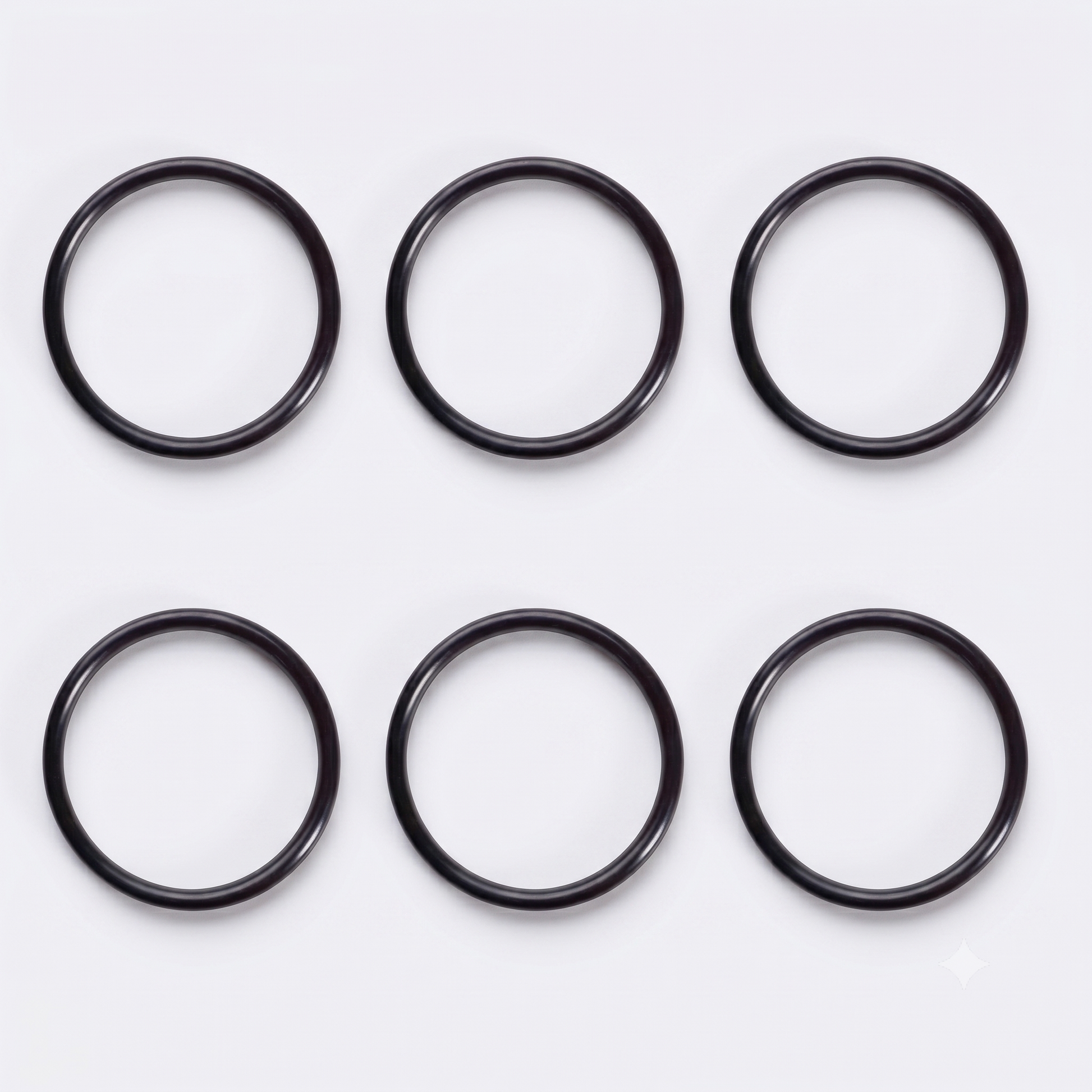 op-down view of six black rubber O-ring seals arranged neatly in a two-by-three grid against a clean, light grey background.