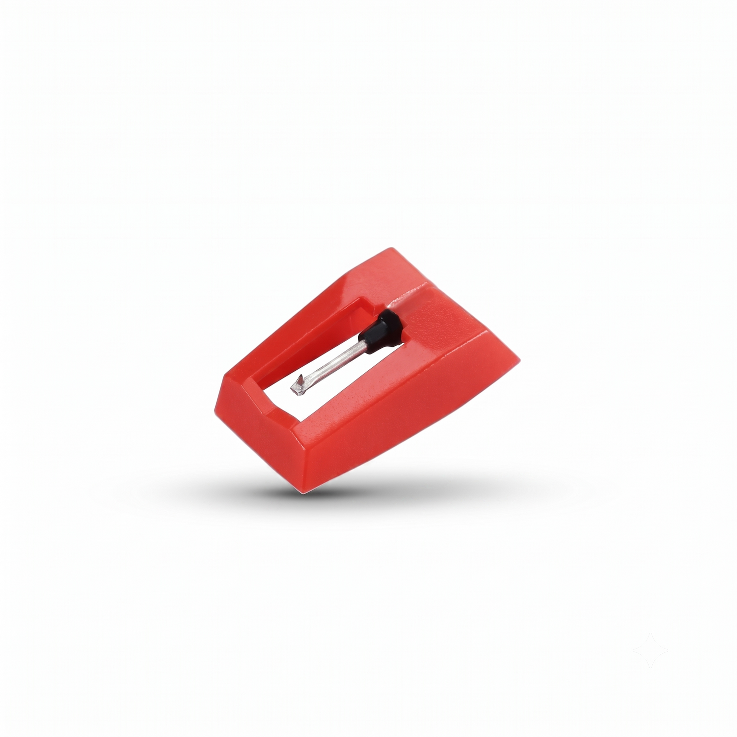 A studio product shot of a bright red plastic turntable stylus (needle) assembly, showing the metal cantilever and diamond tip pointing downward, floating slightly with a soft shadow on a solid white background.