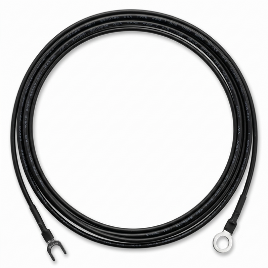 A top-down, studio shot of a black external earthing wire for a Linn LP-12 turntable, coiled into a perfect circle against a clean white background.The wire features different terminals at each end: the bottom-left end terminates in a silver metal fork (spade) connector, while the bottom-right end terminates in a silver metal ring connector. Both connections are neatly sealed with black heat-shrink tubing.