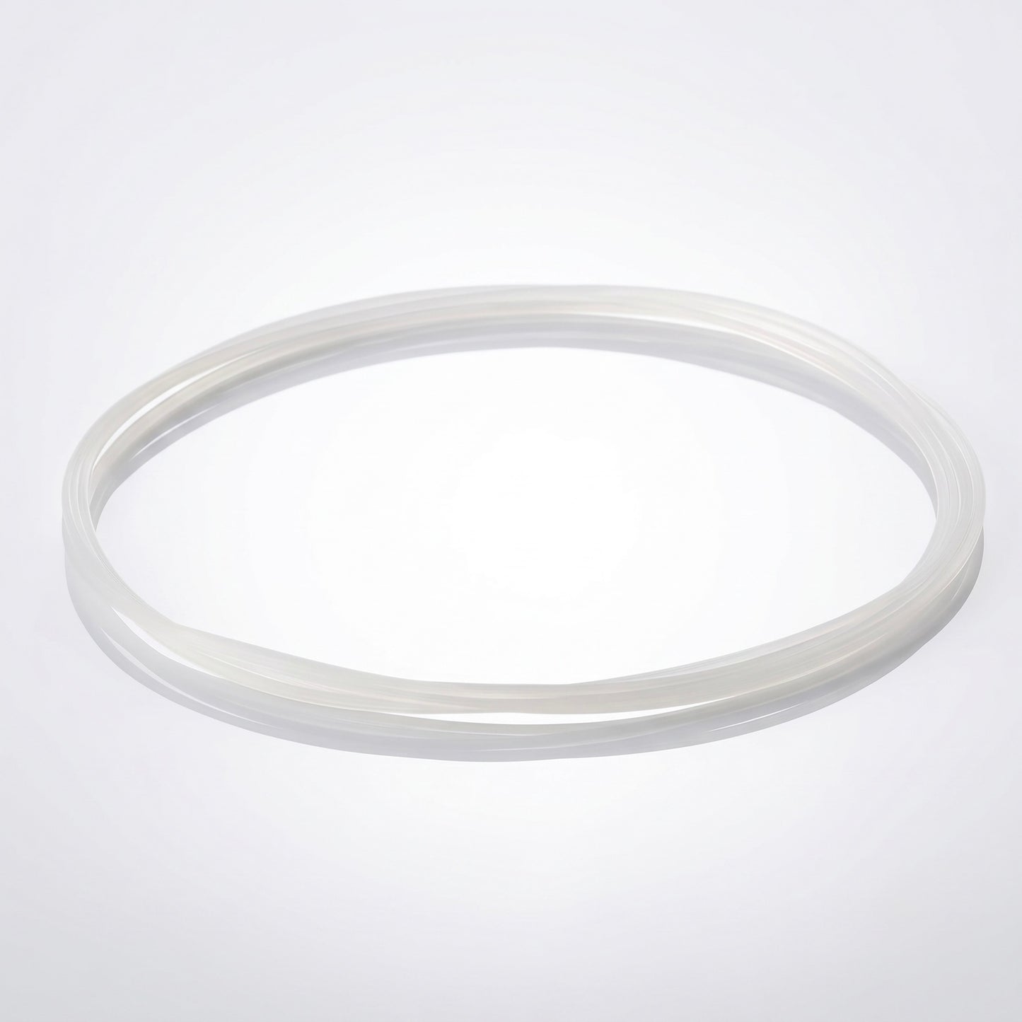 A clear, frosted silicone drive belt for a turntable, looped in a loose circle and resting on a bright, seamless white background.