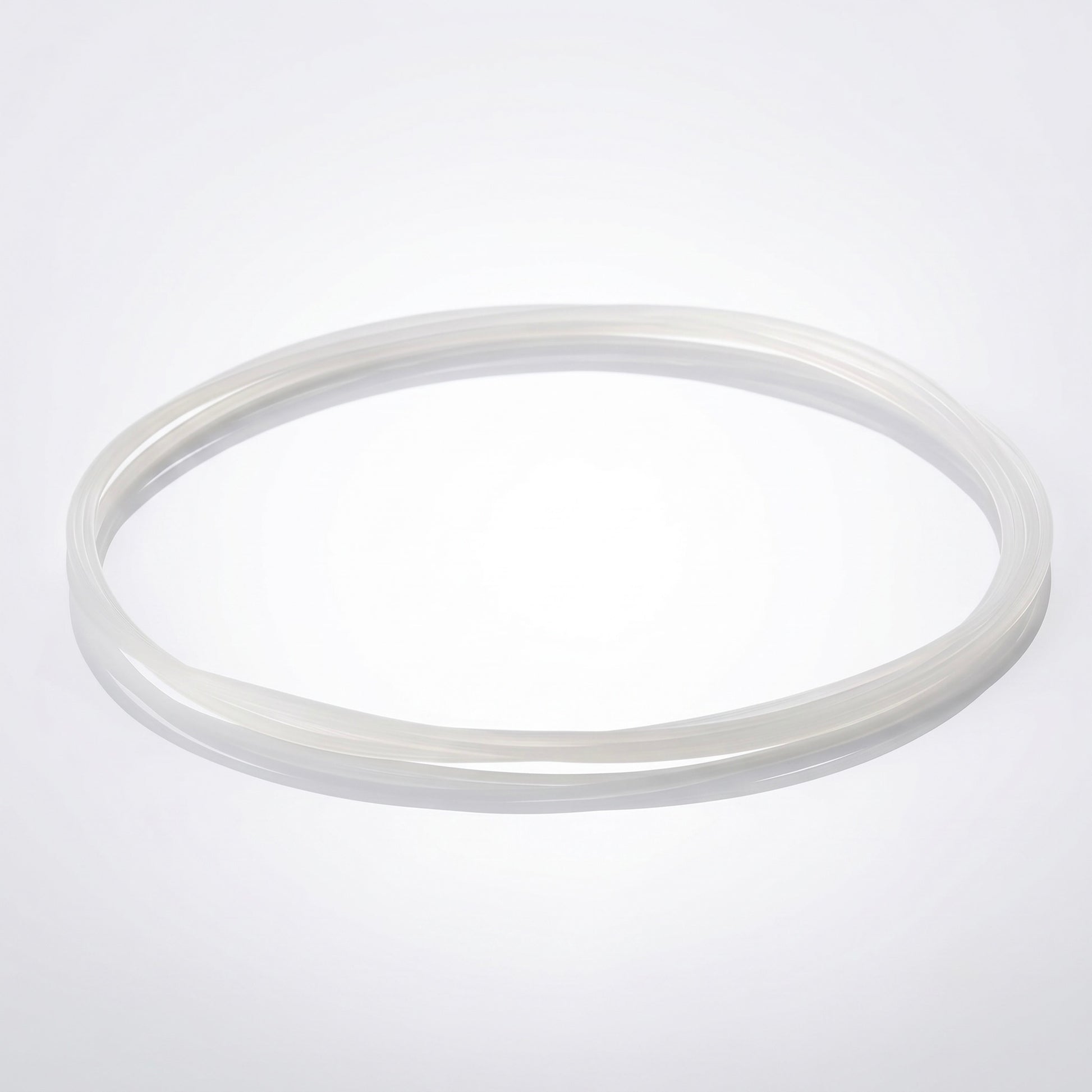 A clear, frosted silicone drive belt for a turntable, looped in a loose circle and resting on a bright, seamless white background.