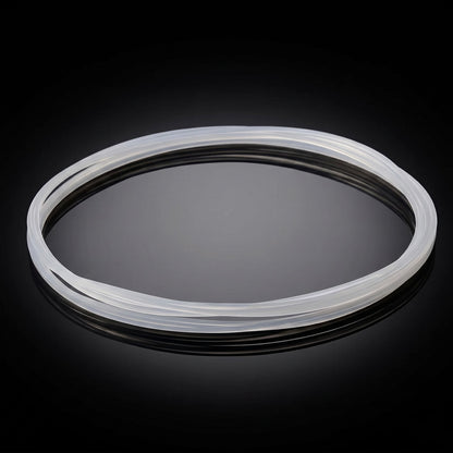 A translucent, white silicone turntable drive belt resting in an oval shape on a reflective, shiny black surface with a dark background.
