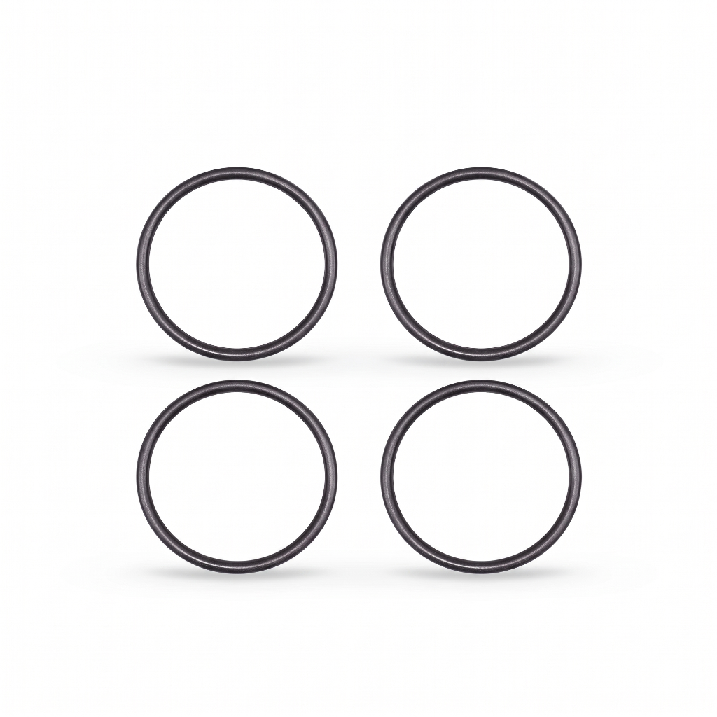 igh-resolution, clean studio shot displaying four identical black rubber O-rings arranged in a neat two-by-two grid against a solid white background. Each circular ring features a smooth, rounded profile with subtle metallic or semi-gloss highlights that give them a three-dimensional appearance. Soft, faint shadows are cast directly beneath each ring, grounding them on the surface.