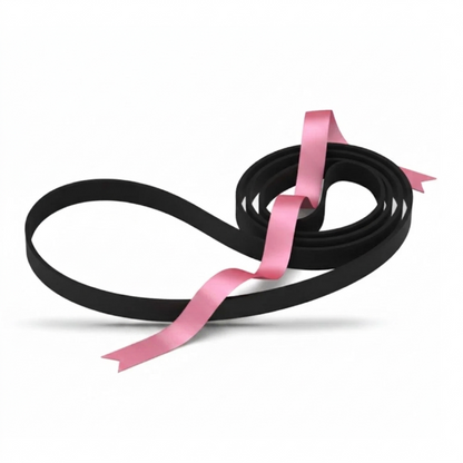 A sleek, black rubber turntable drive belt is arranged on a plain white surface. A shimmering, satin pink ribbon is draped elegantly across it, weaving through the coiled section on the right and extending over the large open loop on the left. The image is clean and minimalist, with soft shadows anchoring the items to the bright background.
