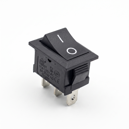 A high-resolution close-up product photo of a black rectangular rocker switch against a plain white background. The switch features a standard vertical line (I) and circle (O) printed in white on its top surface to indicate the on and off positions. Its side housing clearly displays the model number "RS601" along with technical specifications (10A 125V AC, 6A 250V AC, T85/55) and various international certification stamps (VDE, CQC, CE). Three metallic quick-connect spade terminals project from the bottom.