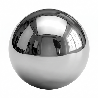 An isolated, highly reflective chrome steel ball bearing sits centered against a solid white background. The upper half of the sphere mirrors a black-and-white photography studio setup, featuring softboxes, light stands, and a large window casting realistic highlights and reflections across its polished, metallic surface.