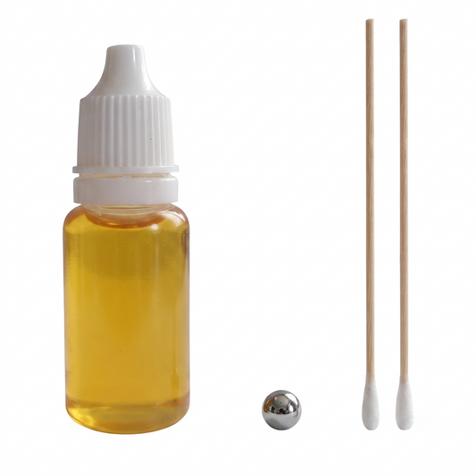 Rega turntable bearing maintenance kit featuring a 10ml clear dropper bottle filled with amber mineral oil, a polished steel ball bearing, and two long cotton-tipped wooden swabs on a clean white background.