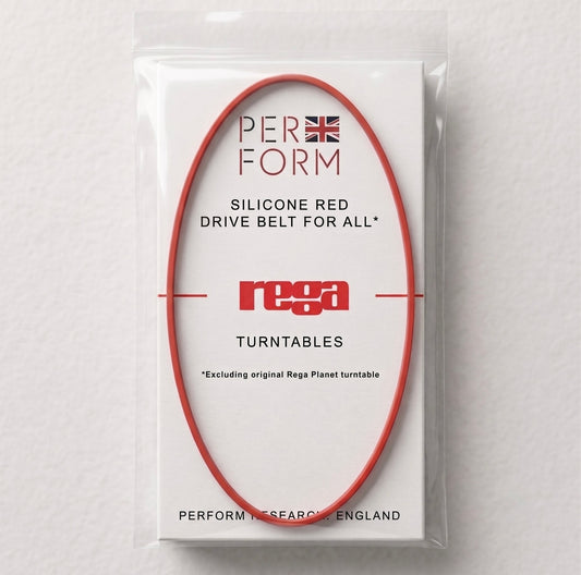 Front view of a "Perform" brand replacement turntable belt. A thin, circular red silicone belt is stretched into an oval shape over a white rectangular card inside a clear plastic packet. The card features text that reads: "PERFORM" with a small Union Jack icon, "SILICONE RED DRIVE BELT FOR ALL* REGA TURNTABLES", and a small note at the bottom stating "*Excluding original Rega Planet turntable". The bottom of the card reads "PERFORM RESEARCH, ENGLAND".