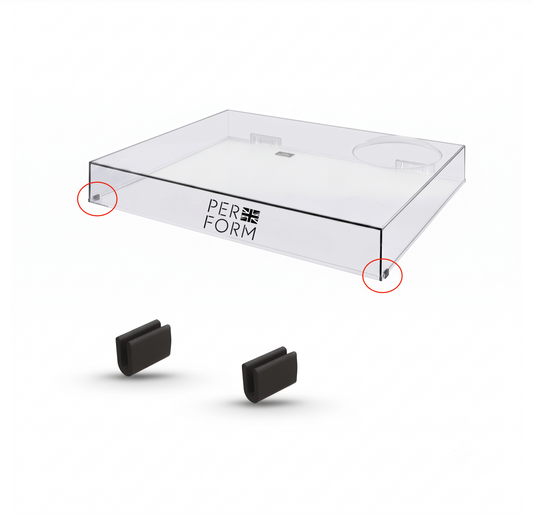 A clear acrylic display tray with the brand name 'PERFORM' printed on the side, shown above two small black accessory pieces on a white background. Red circles highlight the bottom corners of the tray.