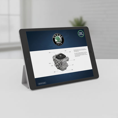 A tablet device on a small stand displaying a Skoda Auto engine diagram and manual page, set on a light gray surface with a softly blurred indoor background.