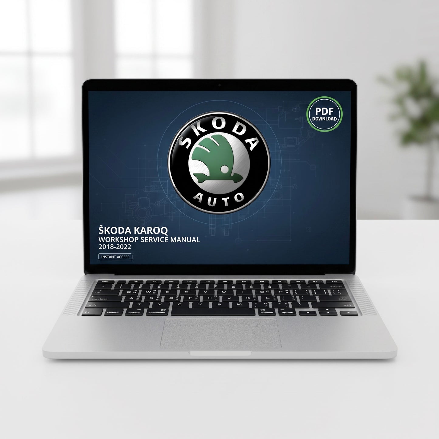 A silver laptop on a white desk displaying a ŠKODA AUTO workshop service manual PDF cover, with a blurred indoor background.
