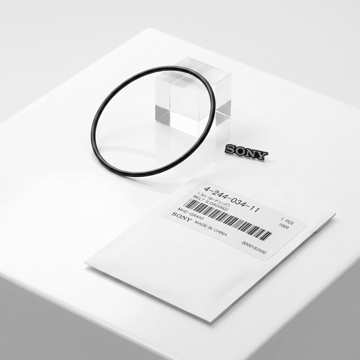 Sony replacement belt packaging, featuring a small black SONY logo and a white paper envelope with a barcode label on a clean white surface.