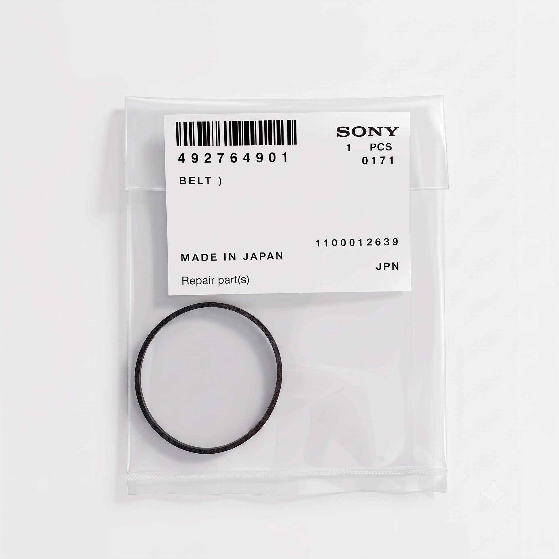 A high-resolution studio photograph taken from a top-down perspective, showcasing an OEM Sony replacement rubber belt sealed inside its original packaging against a clean, solid white background.