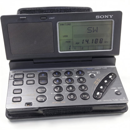 Sony portable radio with an open clamshell design, featuring a digital display screen and a silver and black keypad base.