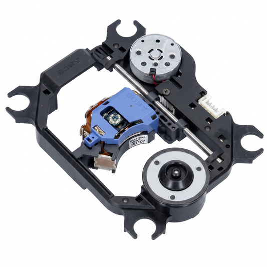 An overhead, slightly angled photograph of a black plastic and metal optical disc drive traverse mechanism, isolated on a white background. The intricate assembly features a prominent blue plastic laser pickup unit, marked with the white text "SONY", "KHM-313AAA", and "181207". This laser unit travels on parallel metal guide rails. Two circular metal dc motors with wires are mounted on opposite corners of the black frame; one has visible vent holes. Various small gears, a white multi-pin connector.