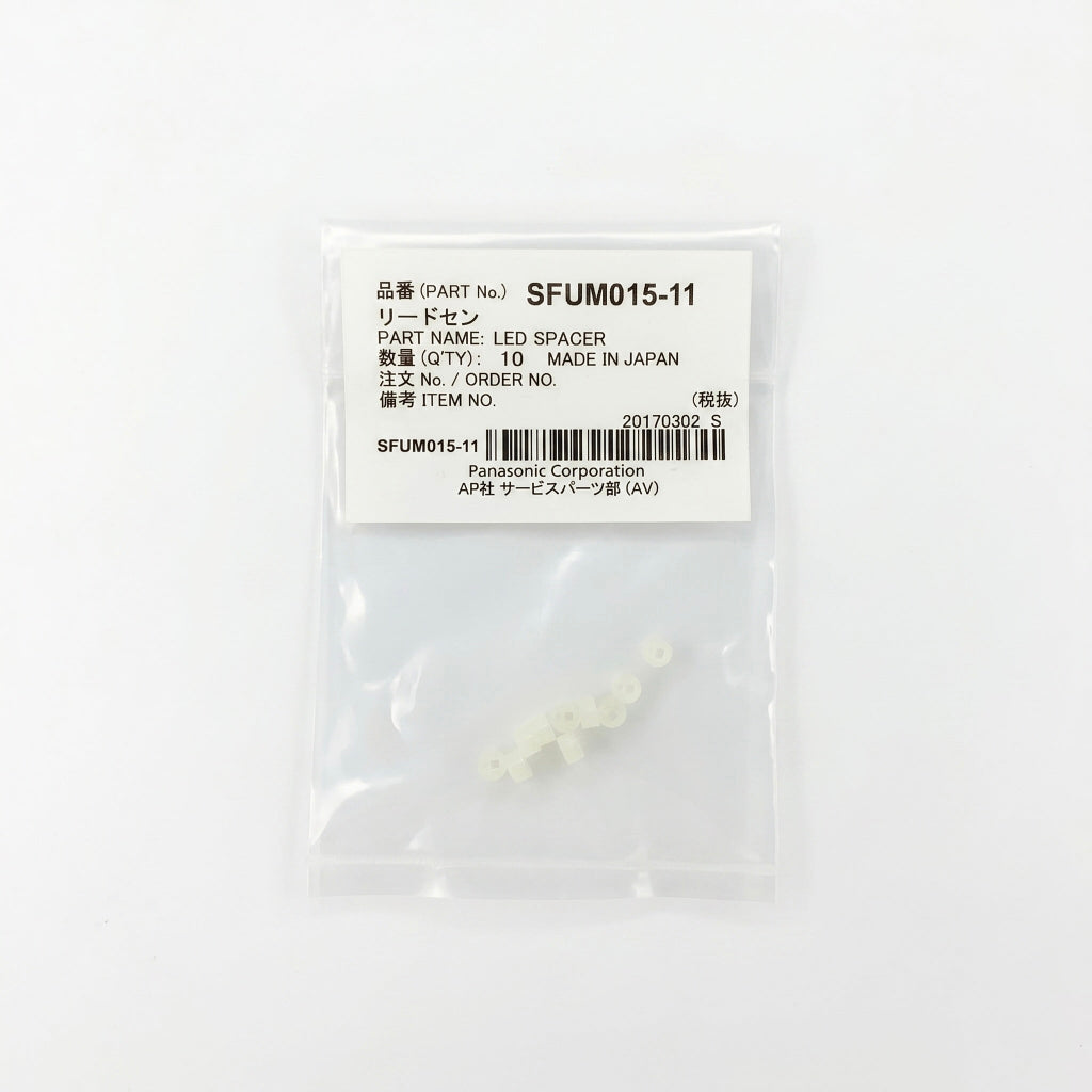 A small, clear plastic bag containing 10 tiny, translucent off-white LED spacers. The top of the bag features a white label with black text displaying 'PART No. SFUM015-11', 'PART NAME: LED SPACER', 'QTY: 10', and 'Panasonic Corporation', alongside a barcode. The package is centered against a clean, solid white background.