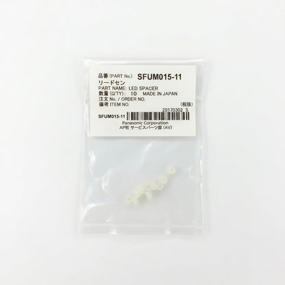 A small, clear plastic bag containing 10 tiny, translucent off-white LED spacers. The top of the bag features a white label with black text displaying 'PART No. SFUM015-11', 'PART NAME: LED SPACER', 'QTY: 10', and 'Panasonic Corporation', alongside a barcode. The package is centered against a clean, solid white background.