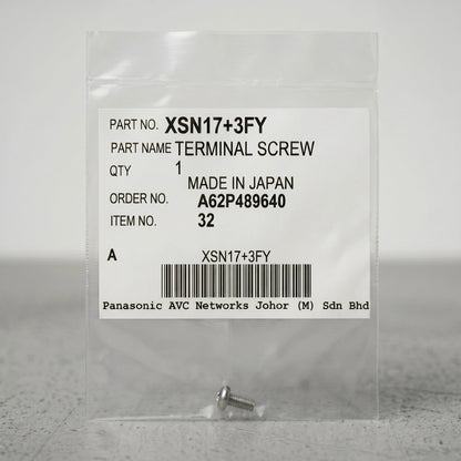A small, silver terminal screw sits at the bottom of a clear, sealed plastic packet against a neutral gray background. The center of the packet features a prominent white product label containing text details and a barcode. The label reads: "PART NO. XSN17+3FY", "PART NAME TERMINAL SCREW", "QTY 1", "MADE IN JAPAN", "ORDER NO. A62P489640", and "ITEM NO. 32". A barcode is centered near the bottom of the label, with "Panasonic AVC Networks Johor (M) Sdn Bhd" printed in a monospace font underneath.