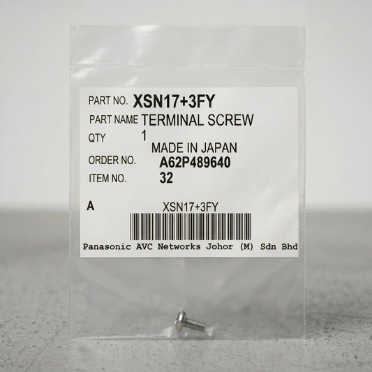 A small, silver terminal screw sits at the bottom of a clear, sealed plastic packet against a neutral gray background. The center of the packet features a prominent white product label containing text details and a barcode. The label reads: "PART NO. XSN17+3FY", "PART NAME TERMINAL SCREW", "QTY 1", "MADE IN JAPAN", "ORDER NO. A62P489640", and "ITEM NO. 32". A barcode is centered near the bottom of the label, with "Panasonic AVC Networks Johor (M) Sdn Bhd" printed in a monospace font underneath.
