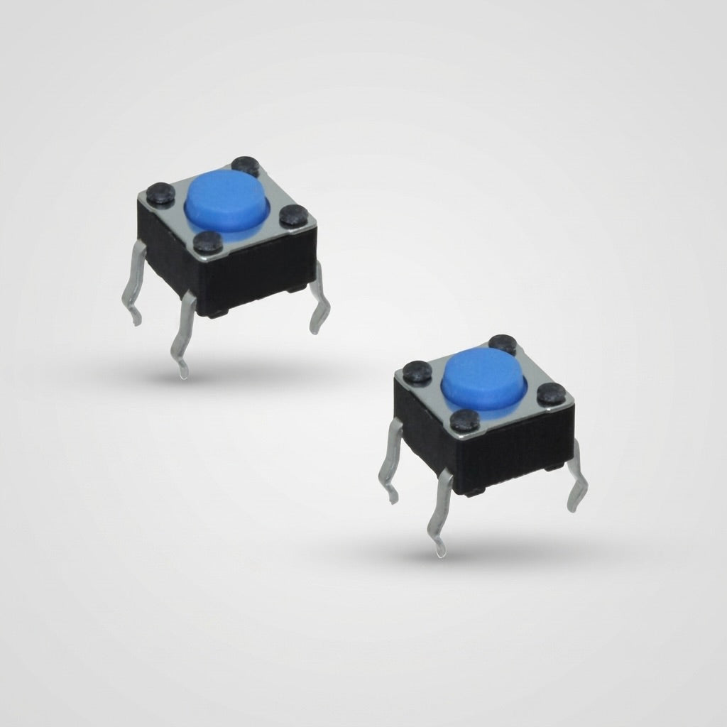 Two square tactile switches with round blue buttons, metal frames, and four metal legs on a light grey background, with text on the left switch.