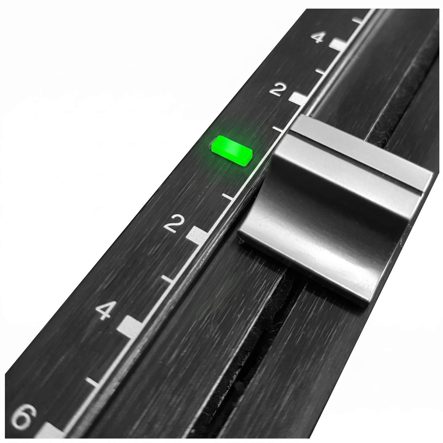 Close-up of a black brushed-metal slider or switch with white numerical markings and a small glowing green indicator light, shown on a plain white background.