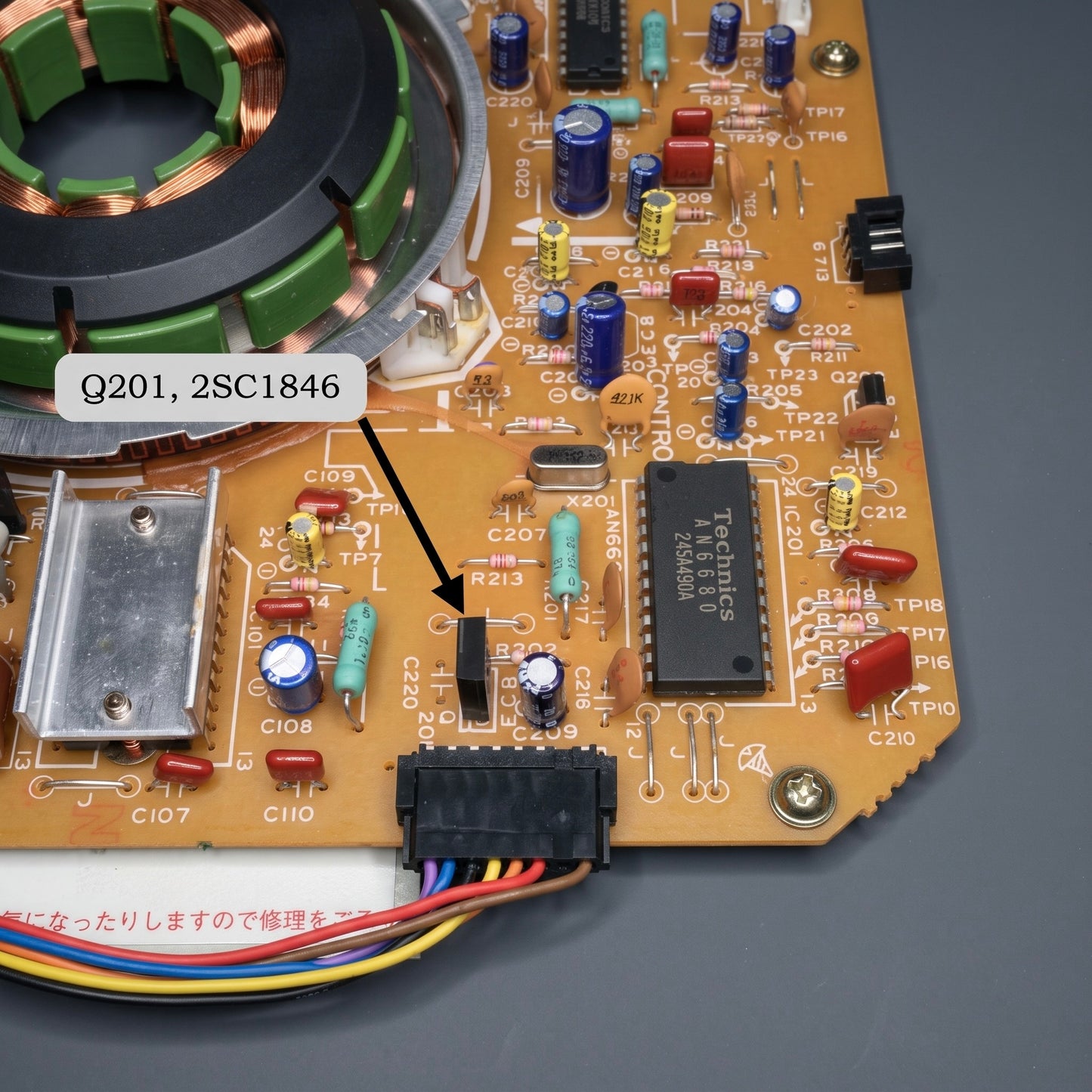 A close-up shot focusing on a specific section of the main circuit board inside a Technics SL-1200 or SL-1210 turntable.

A black arrow points directly to a small, black, three-pronged transistor labeled Q201 on the tan printed circuit board (PCB). A floating white text box near the top left reads "Q201, 2SC1846" to specify the component part number.