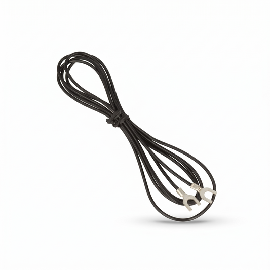 A product shot from Yamaha_GT-5000 showing a thin black ground wire bundled in a loose figure-eight loop against a plain white background. The center of the bundle is secured with a small black twist tie. The two ends of the cable extend out, each terminated with a silver spade-connector (u-shaped terminal fork). A soft, subtle shadow is cast underneath the wire loops on the lower right.