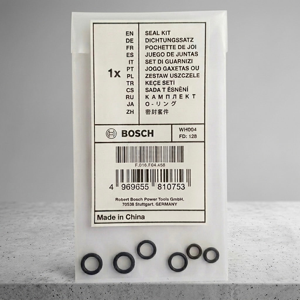 Bosch seal kit in its original white packaging box, with several black rubber O-rings arranged in a row in front of the box on a light gray surface.