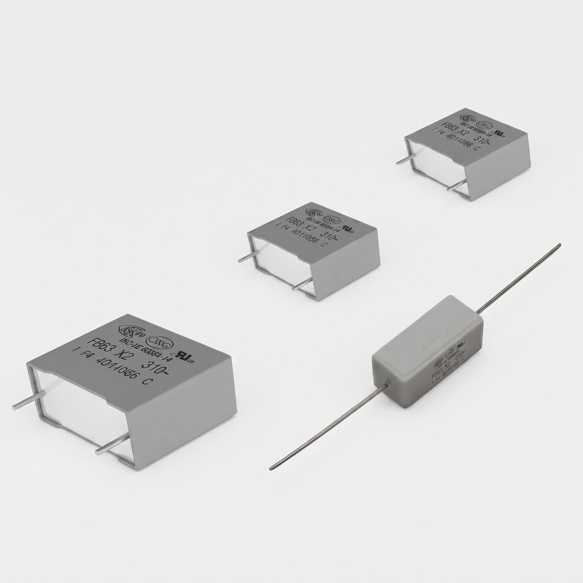 Dual CS505 turntable motor PCB repair kit featuring three grey X2 class safety capacitors and one rectangular flame-retardant resistor with wire leads, isolated on a white background.