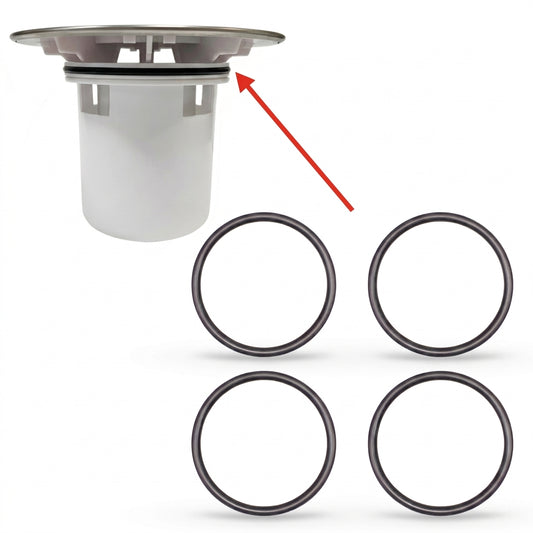Product diagram showing a white cylindrical shower tray waste dip tube with a chrome top flange. A red diagonal arrow points directly to a black rubber O-ring seal fitted near the top section of the dip tube assembly. Below the main assembly, four identical black replacement rubber O-rings are arranged in a two-by-two grid against a plain white background.