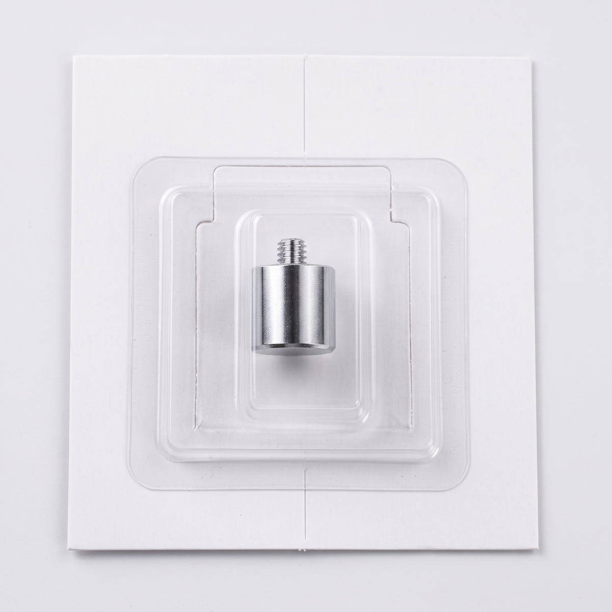 A silver metal Counterweight with a threaded top, sealed inside a clear plastic protective blister pack on a white square backing card.