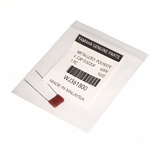 A close-up photograph of a small electronic component in a clear plastic resealable bag on a light-colored surface. The bag contains a brown metallized polyester film capacitor with two long metal leads extending from its body. A white label is affixed to the bag, featuring the following printed text: YAMAHA GENUINE PARTS at the top in a black bar, below which reads METALLIZED POLYESTE, F. CAP 0.022UF, 630V, 1 PC, 1020.