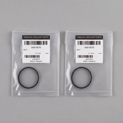 Two clear plastic bags containing black rubber belts with white Yamaha Genuine Parts labels, shown on a plain grey background.